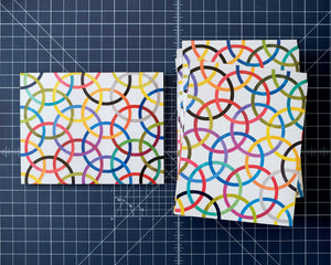 Packing folded up displayed front and back, featuring vibrant high-res prints of patchwork.